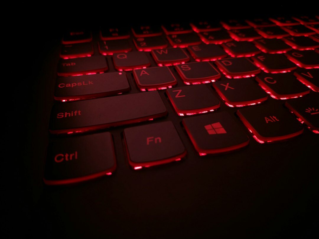 Laptop keyboard with encrypted code on screen in low light