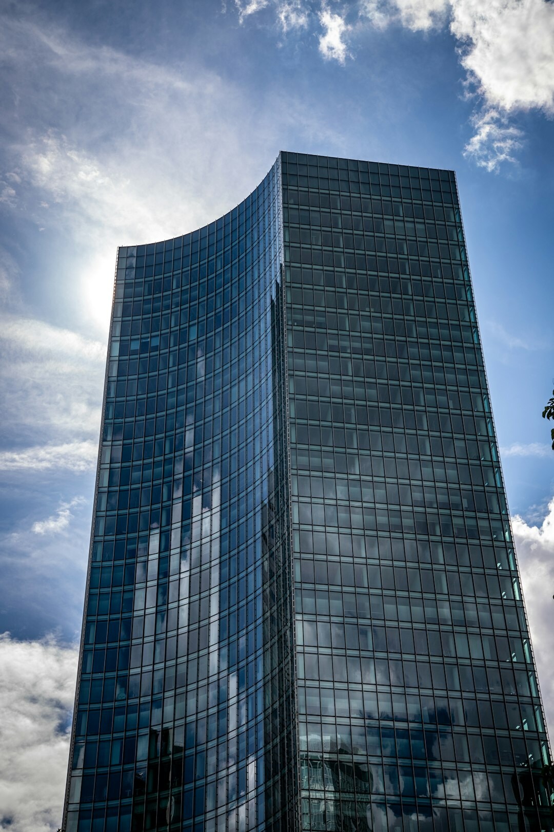 Modern Swiss bank headquarters glass tower against blue sky